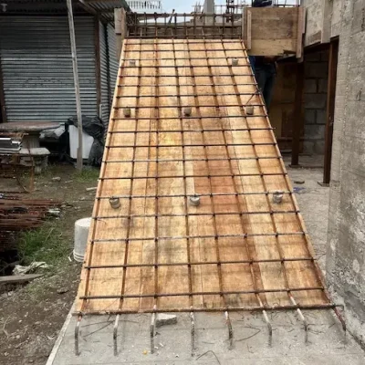 Wood formwork with steel rebar mesh for sloped slab under construction