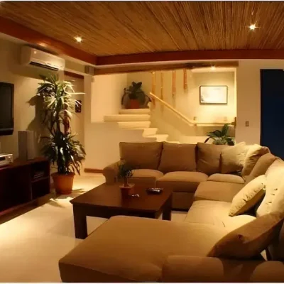 Modern living room interior with L-shaped sofa and bamboo ceiling in Costa Rica